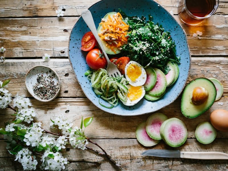 A colorful plate of grilled chicken, rice, and vegetables being photographed with SnapBites for instant nutrition tracking